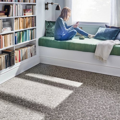 woman reading in bedroom - Whitley Flooring and Design in AR